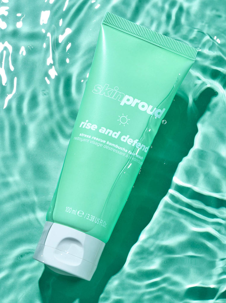 Bottle of Skin Proud Rise and Defend Face Wash splashing in water