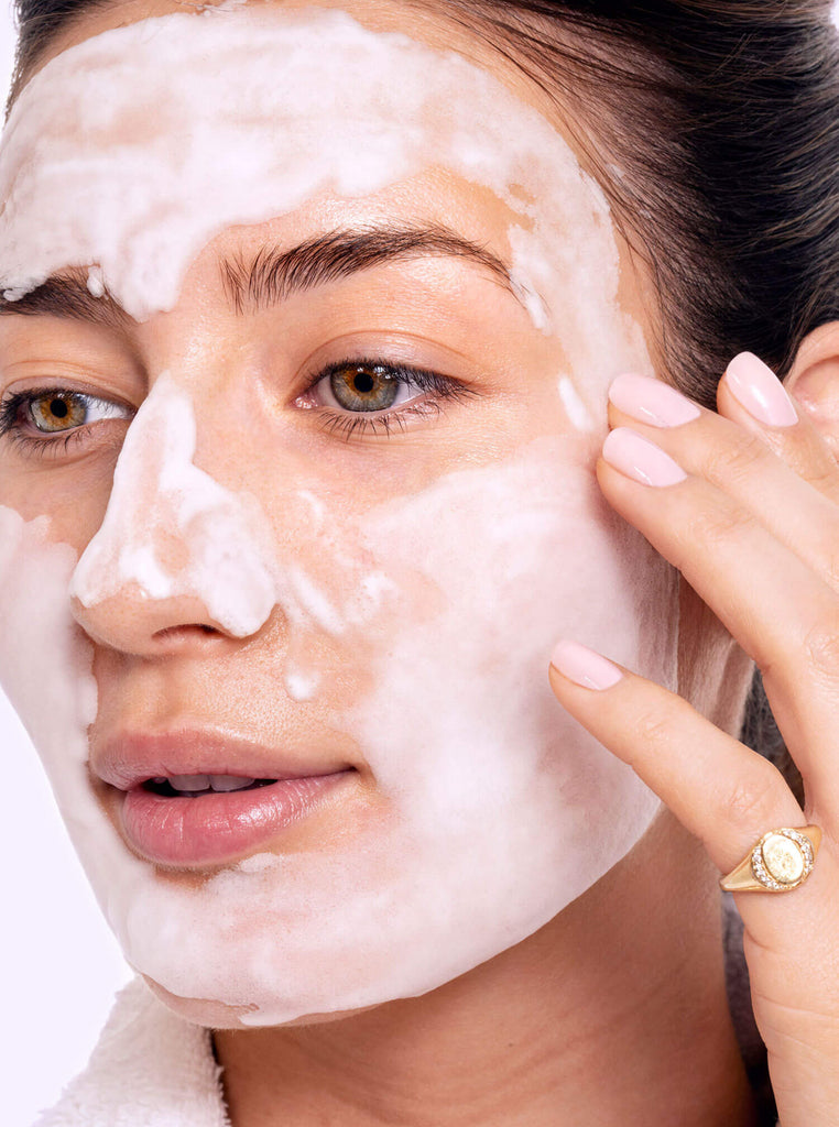Female model using a foaming face mask