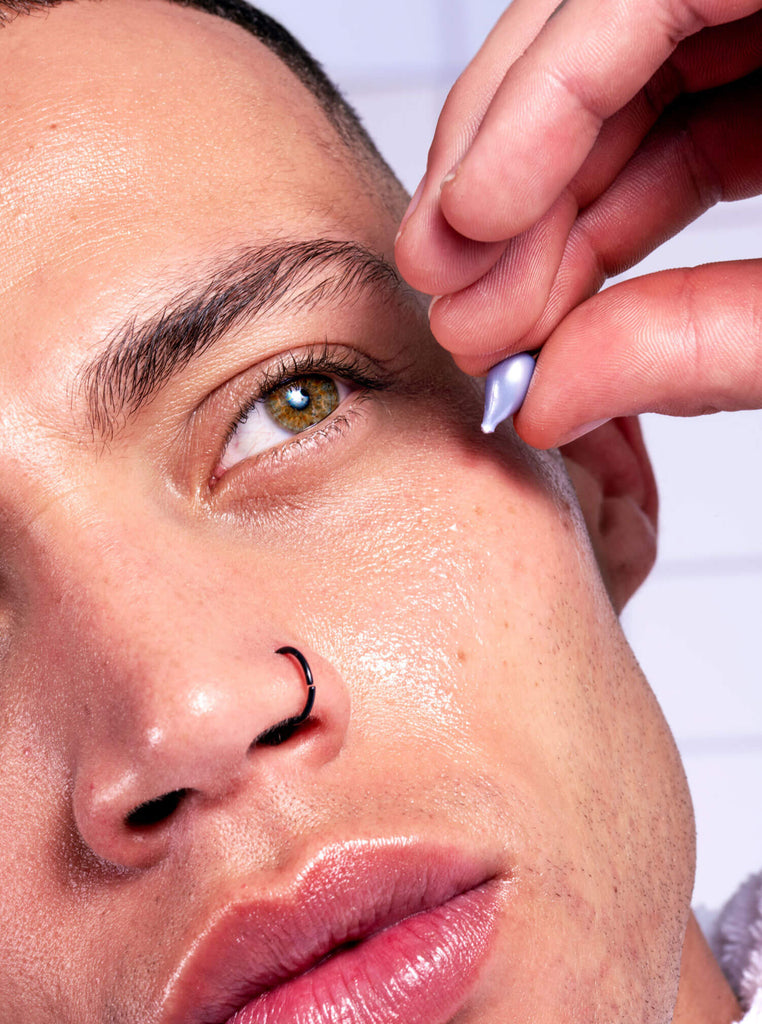 Male model applying Proud Pod to cheek