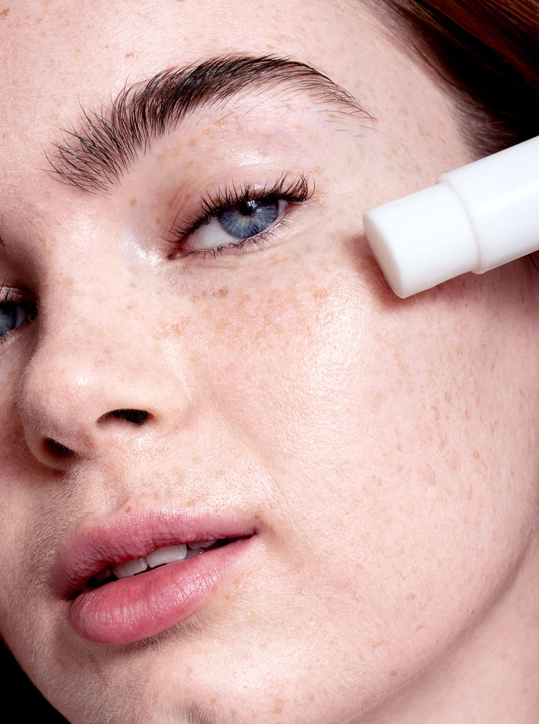 Close up of model applying Skin Proud Icicle cooling eye balm