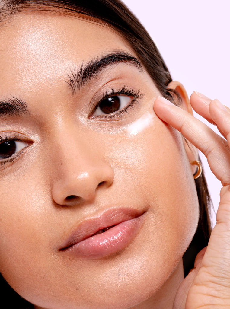 Female model applying Bright Eye eye cream