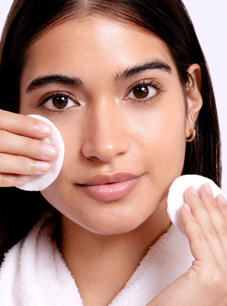 Model applying Detox Tonic with cotton pad