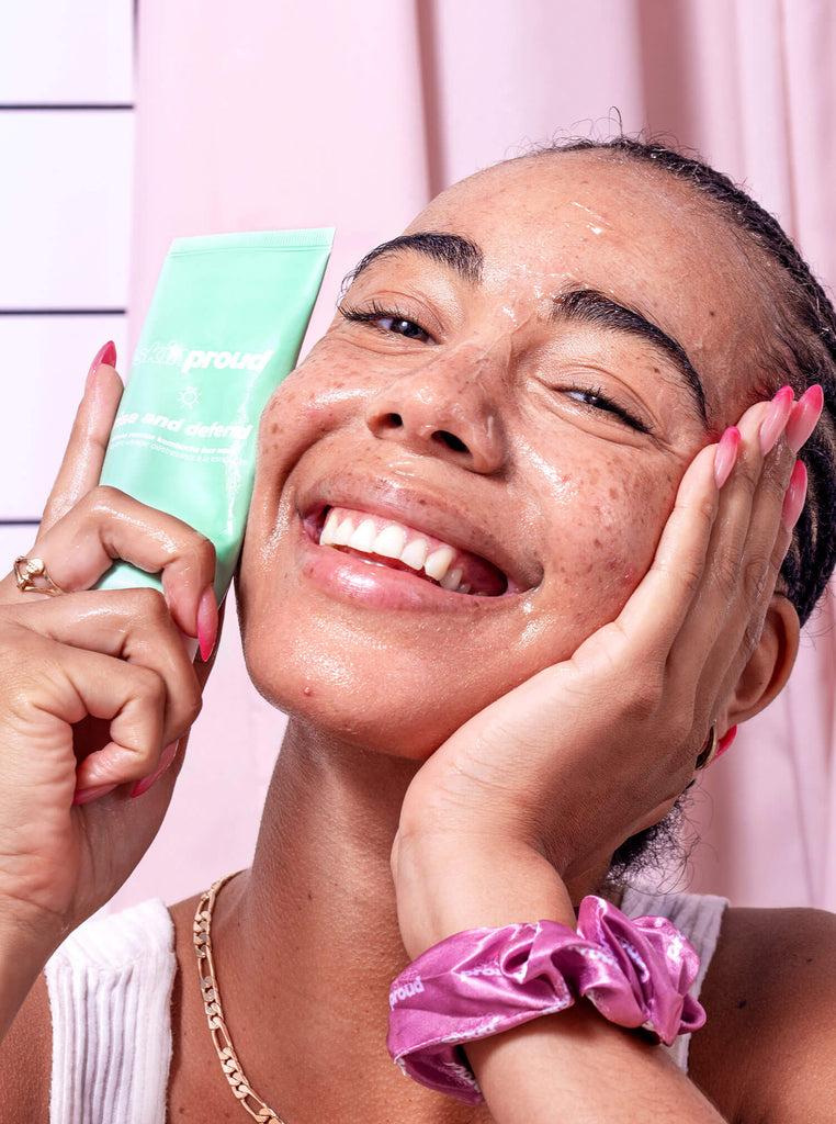 Smiling model holding tube of Rise and Defend